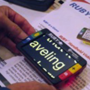 photograph of a person using an electronic magnifier